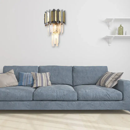 Modern gold and black crystal sconce light fixture with geometric design and cascading clear prisms for bedroom wall use