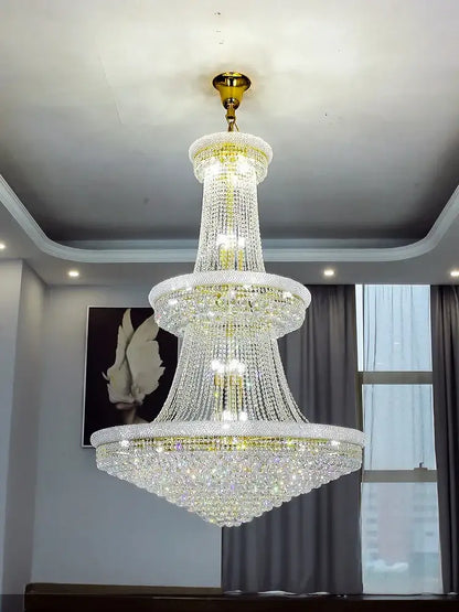 Modern gold and black pendant light with metal finish and cascading crystal tiers for staircase or dining room use