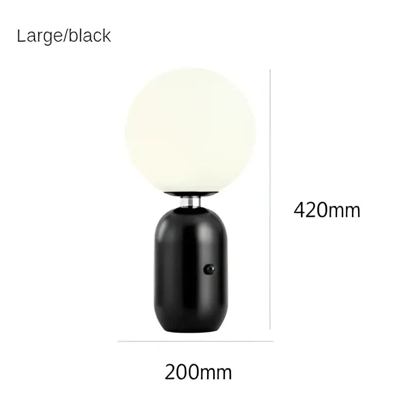 Modern gold and black decorbites glass ball led desk lamp with a black spherical matte lamp and cylindrical base for bedroom light