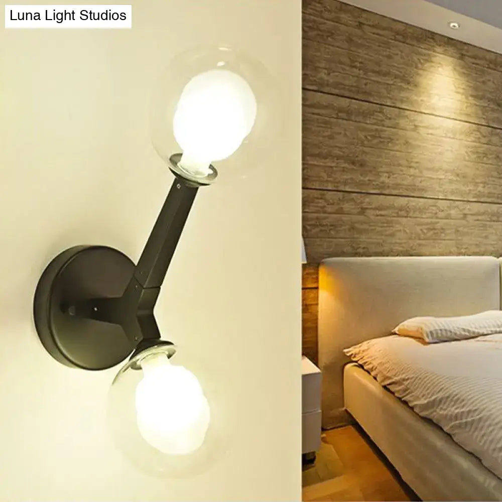 Black metal double globe wall lamp with two exposed bulbs designed as a modern corridor sconce light