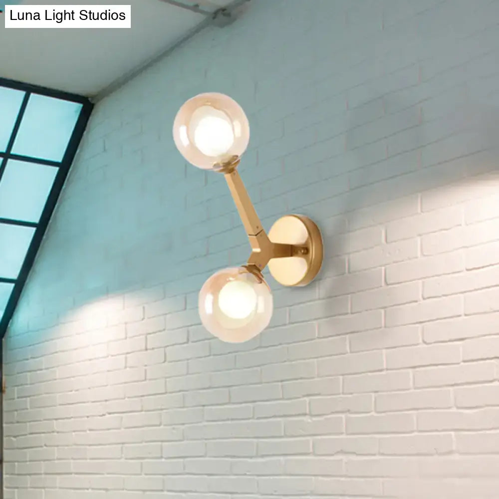 Modern gold and black double globe wall lamp featuring two gold-toned spherical glass globes for corridor lighting