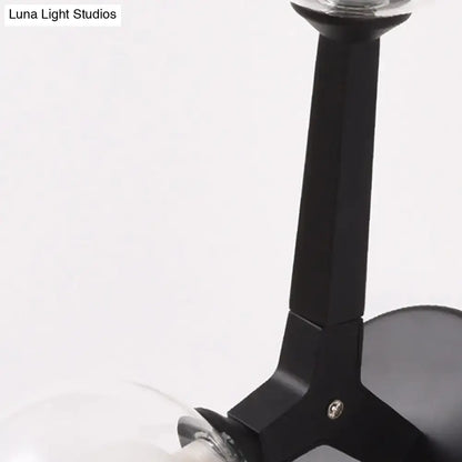 Modern gold and black double globe wall lamp featuring a black matte metal arm with a clear glass bulb globe wall lamp