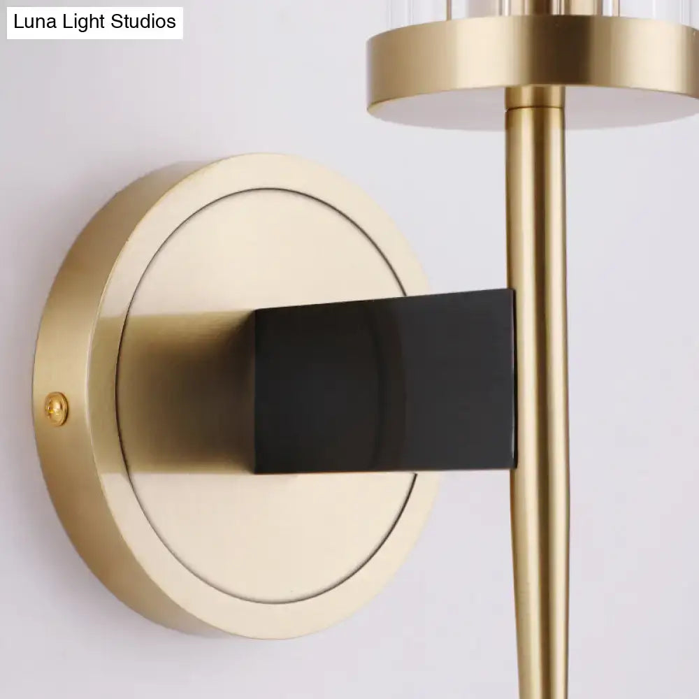 Modern gold and black wall lamp with brass finish fluted glass shade and sleek rectangular accent for bedroom use
