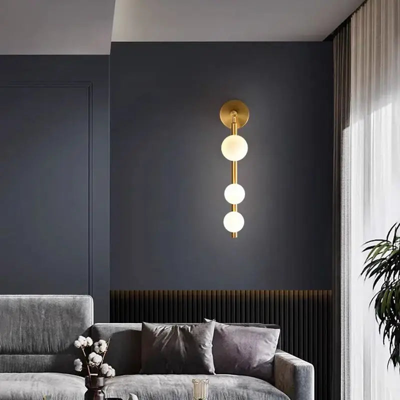 Modern gold and black glass ball wall lights with three spherical frosted glass bulbs for living room decorbites decor