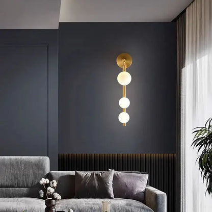 Modern gold and black glass ball wall lights with three spherical frosted glass bulbs for living room decorbites decor