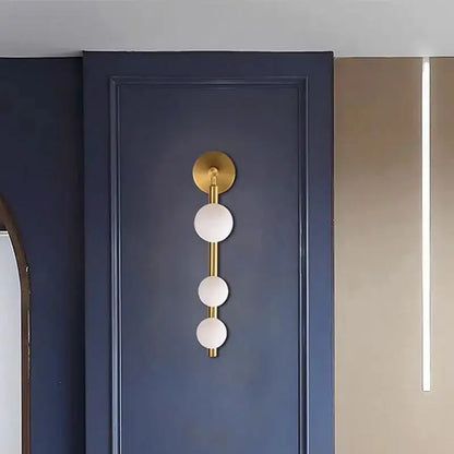 Modern gold and black glass ball wall lights feature a gold-toned wall sconce with three frosted glass spheres stacked vertically decorbites glass ball wall