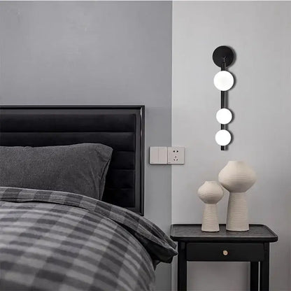 Black wall-mounted glass ball wall lights with three vertically aligned bulbs for modern decorbites living room decor