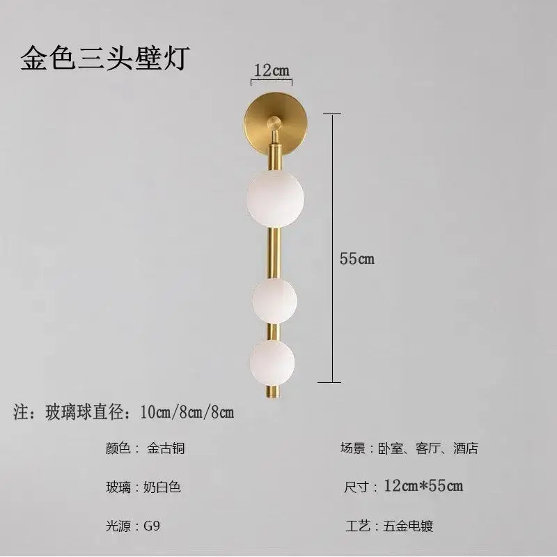Gold-toned three-head wall lights with frosted glass spheres and sleek brass finish for decorbites glass ball wall decor