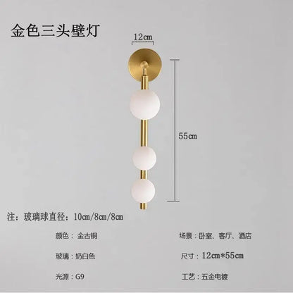 Gold-toned three-head wall lights with frosted glass spheres and sleek brass finish for decorbites glass ball wall decor