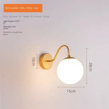 Modern gold and black decorbites glass ballight wall lamp with milky glass globe and curved wrought iron arm for bedroom sconce