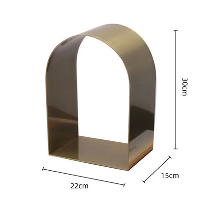 A sleek modern gold and black golden arches metal sculpture bookshelf with a polished brass finish for decorbites decor