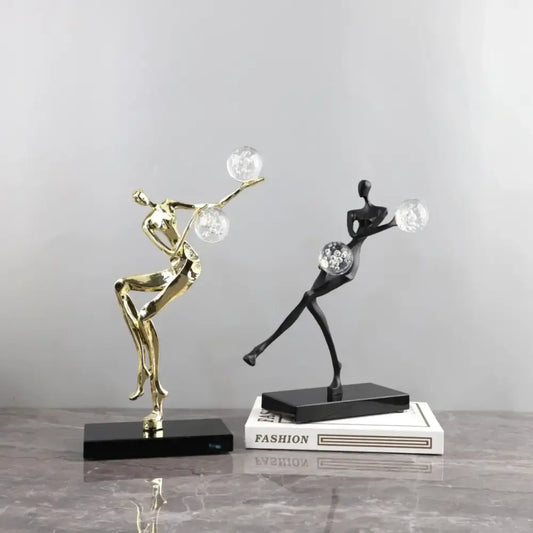 Two sleek gold and black crystal ball golden man figurines for modern living room decor by decorbites golden man