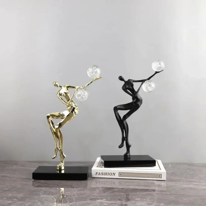Elegant gold and black golden man crystal ball sculpture with clear orbs for modern living room decor by decorbites