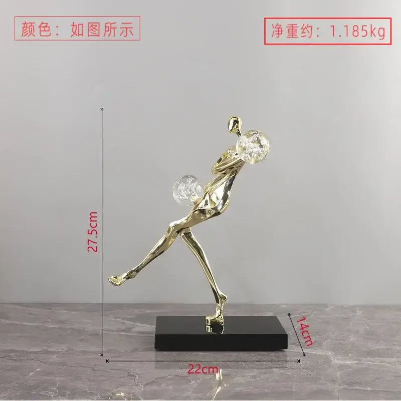 Modern gold and black golden man crystal ball sculpture featuring a dynamic dancer figurine on black base decorbites golden man