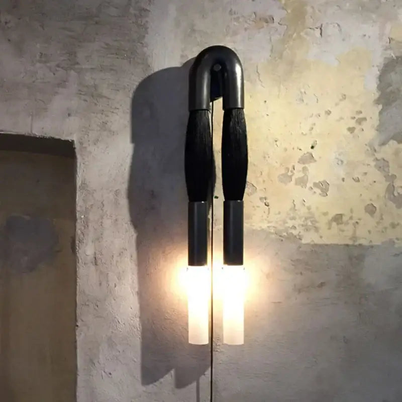 Black u-shaped wall lamp with frosted glass shades emitting warm light in modern decorbites horsehair wall lamp design