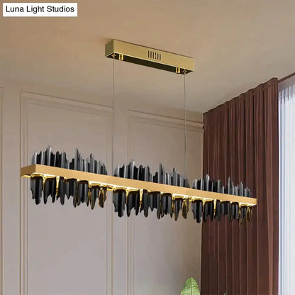 Modern gold and black DecorBites Irene LED chandelier lighting with sleek mountain-like design for dining room use
