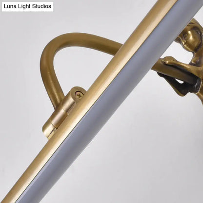 Modern gold and black wall sconce with brushed brass arm and ornate monkey clasp holds frosted glass tube light fixture height inches