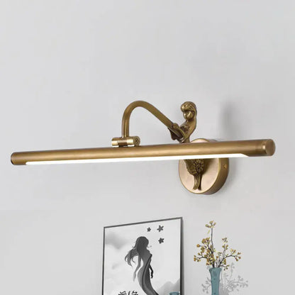 Modern gold and black wall sconce with antique brass finish, cherub figure, and elongated light bar, fixture height 15 inches