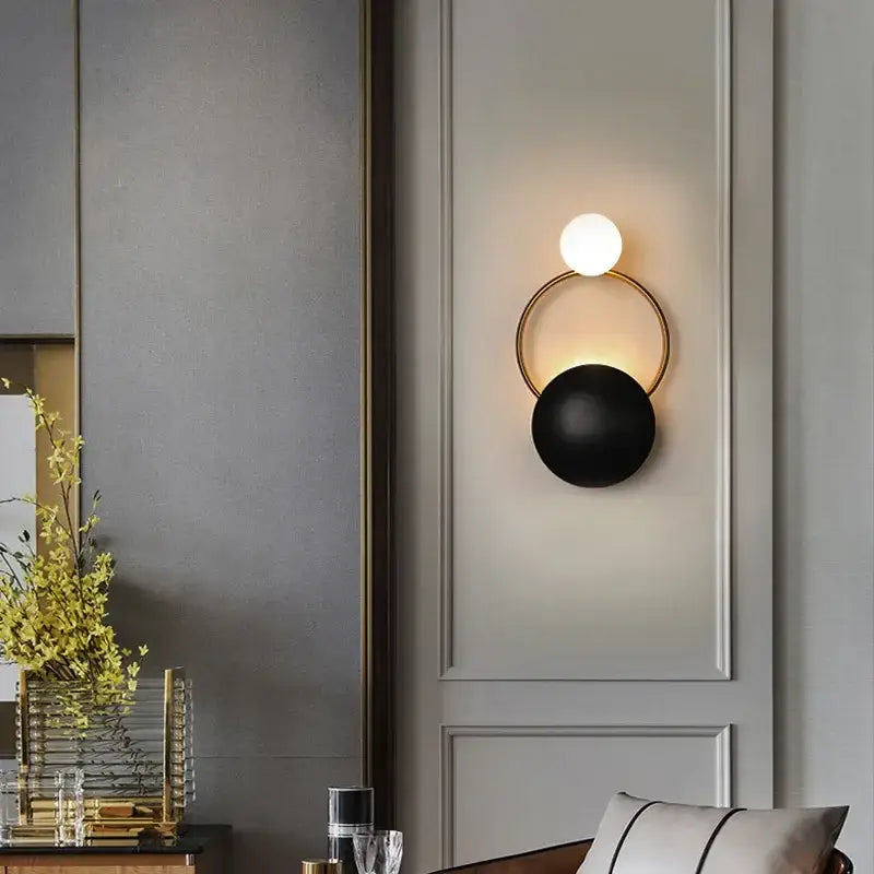 Modern gold and black led wall sconce with a circular frame and dual spherical shades for elegant living room decorbites decor