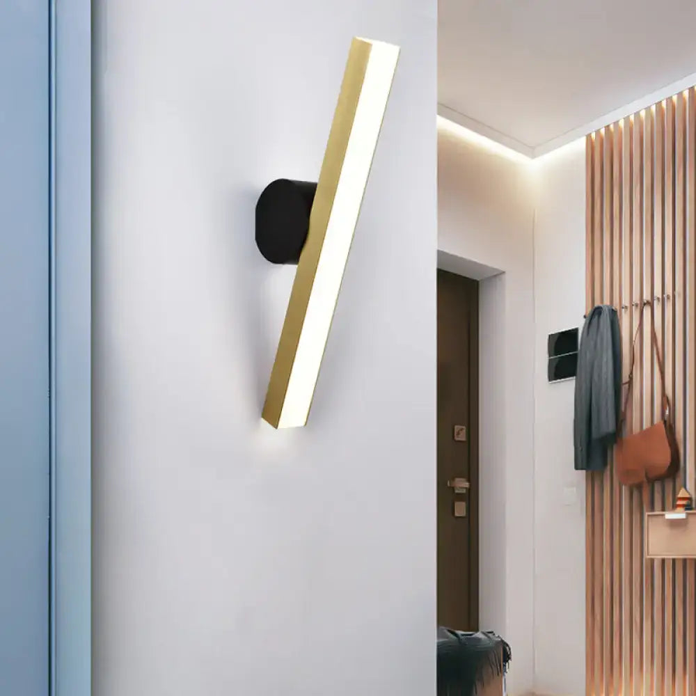 Modern gold and black led wall sconce with gold finish and sleek black base showcasing fixture width for living room use