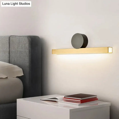 Modern gold and black led wall sconce with sleek rectangular bar and matte black circular accent for living room fixture width