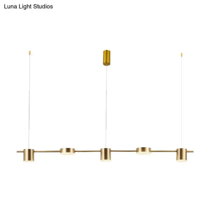 DecorBites modern gold-toned linear chandelier with four cylindrical fixtures offers warm white light and rotatable shades