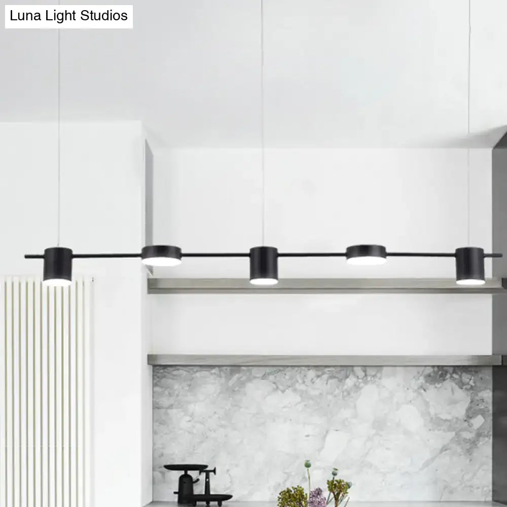 Black DecorBites™ modern cylindrical pendant lights with rotatable shade in warm white light for minimalist kitchen