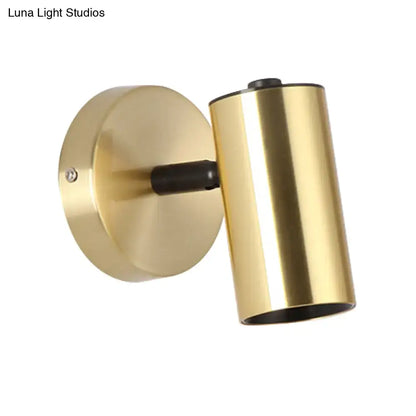 Modern gold and black metallic tube led light bedside wall sconce with cylindrical gold finish and matte black accents