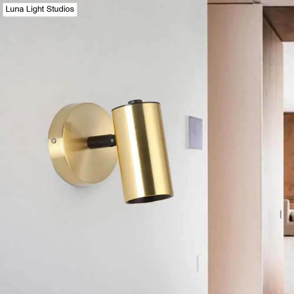 Modern gold and black metallic tube led light bedside wall sconce with gold-finished cylindrical design and matte black accent arm