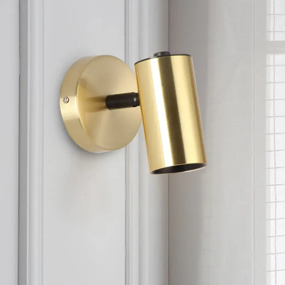 Modern gold and black metallic tube led light bedside wall sconce with a gold-finished cylindrical shade and matte black accent arm