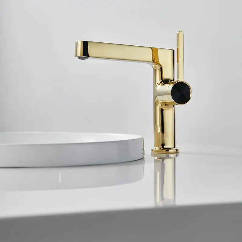 Modern gold and black minimalist basin faucet with sleek design and black circular handle by decorbites basin faucet