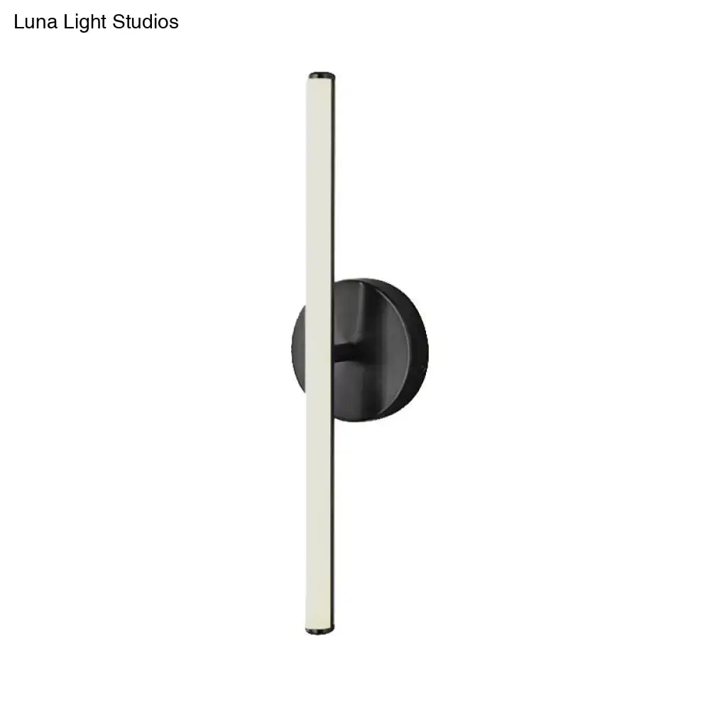 Modern gold and black wall sconce with sleek vertical led light tube in a minimalist bathroom wall light design
