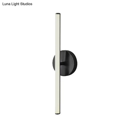 Modern gold and black wall sconce with sleek vertical led light tube in a minimalist bathroom wall light design