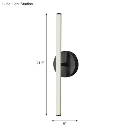 Modern black wall sconce with a sleek cylindrical light fixture and gold finish minimalist wall light for bathroom use