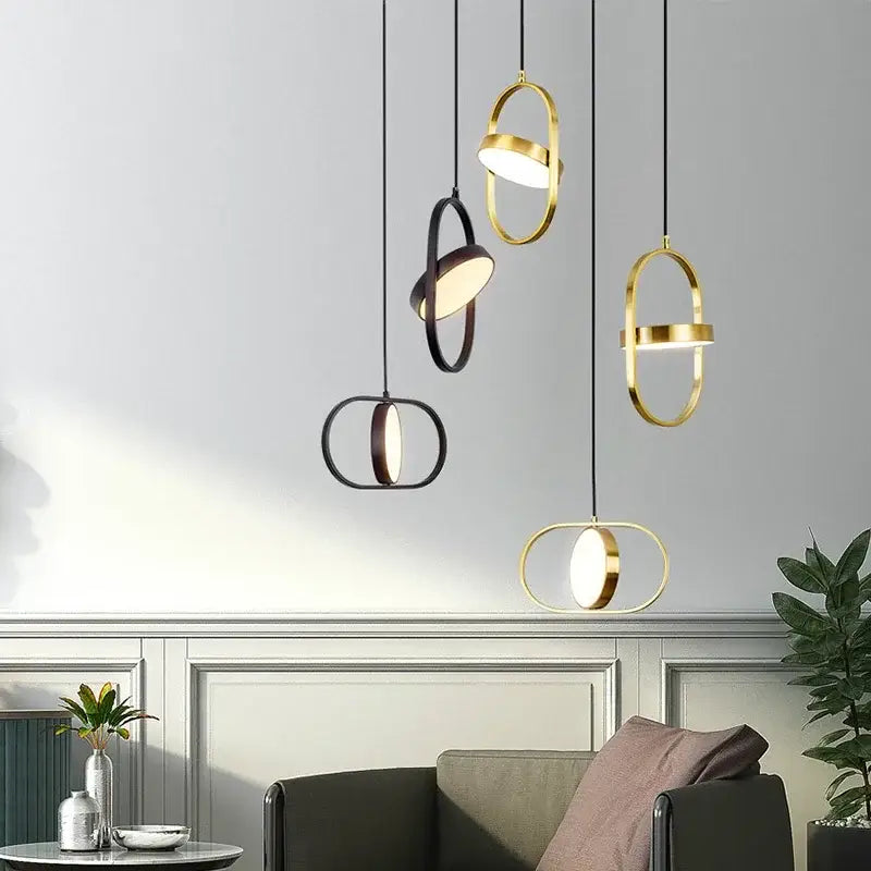 Modern gold and black oval pendant lights with sleek interlocking ring designs for kitchen decorbites gold pendant lighting