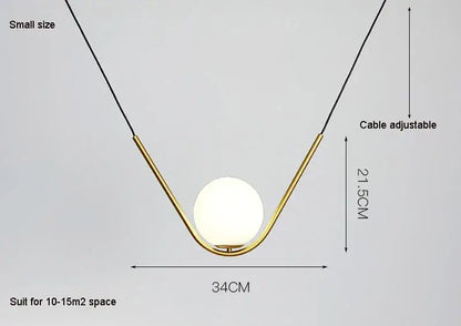 Modern gold black pendant light with v-shaped gold-toned frame and frosted glass globe for dining room decorbites golden black perle