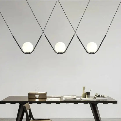 Modern black metal pendant light with three spherical white glass globes for dining room decorbites golden black style