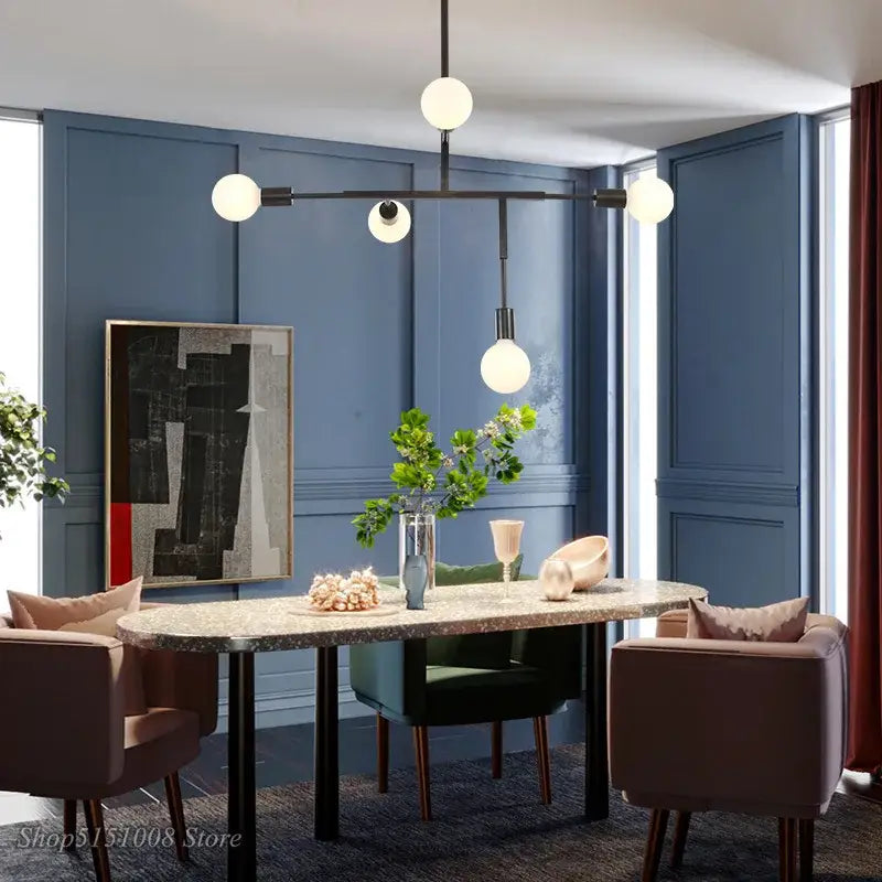 Modern gold and black pendant light with black finish featuring spherical white glass globes for dining room decorbites cross style