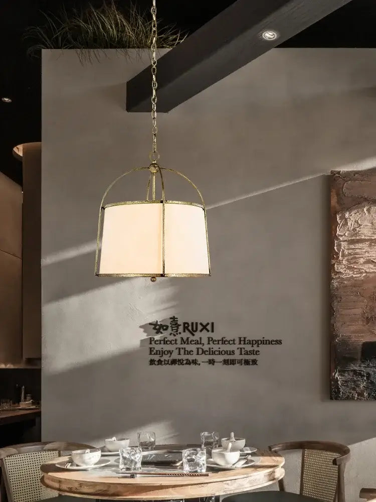Brass-framed pendant light with cream fabric shade from decorbites gold black pendant collection for dining room decor
