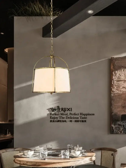 Brass-framed pendant light with cream fabric shade from decorbites gold black pendant collection for dining room decor