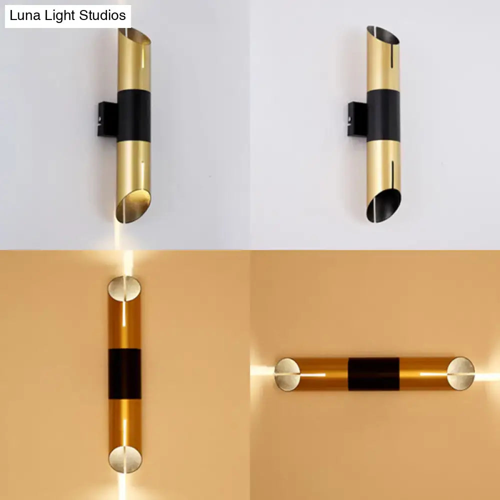 Modern gold and black rotatable cylinder wall sconce with sleek minimalist design for bedroom lighting