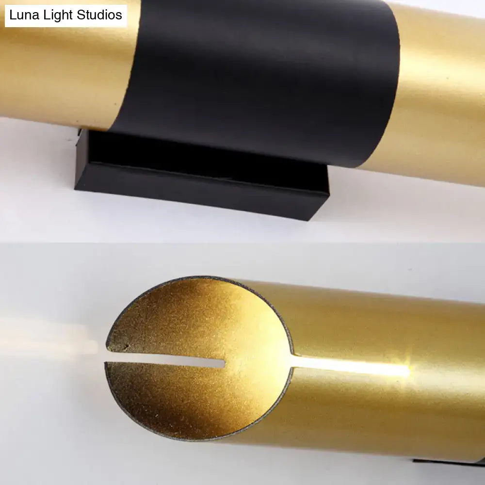 Modern gold and black rotatable cylinder wall sconce with a sleek minimalist design for bedroom lighting