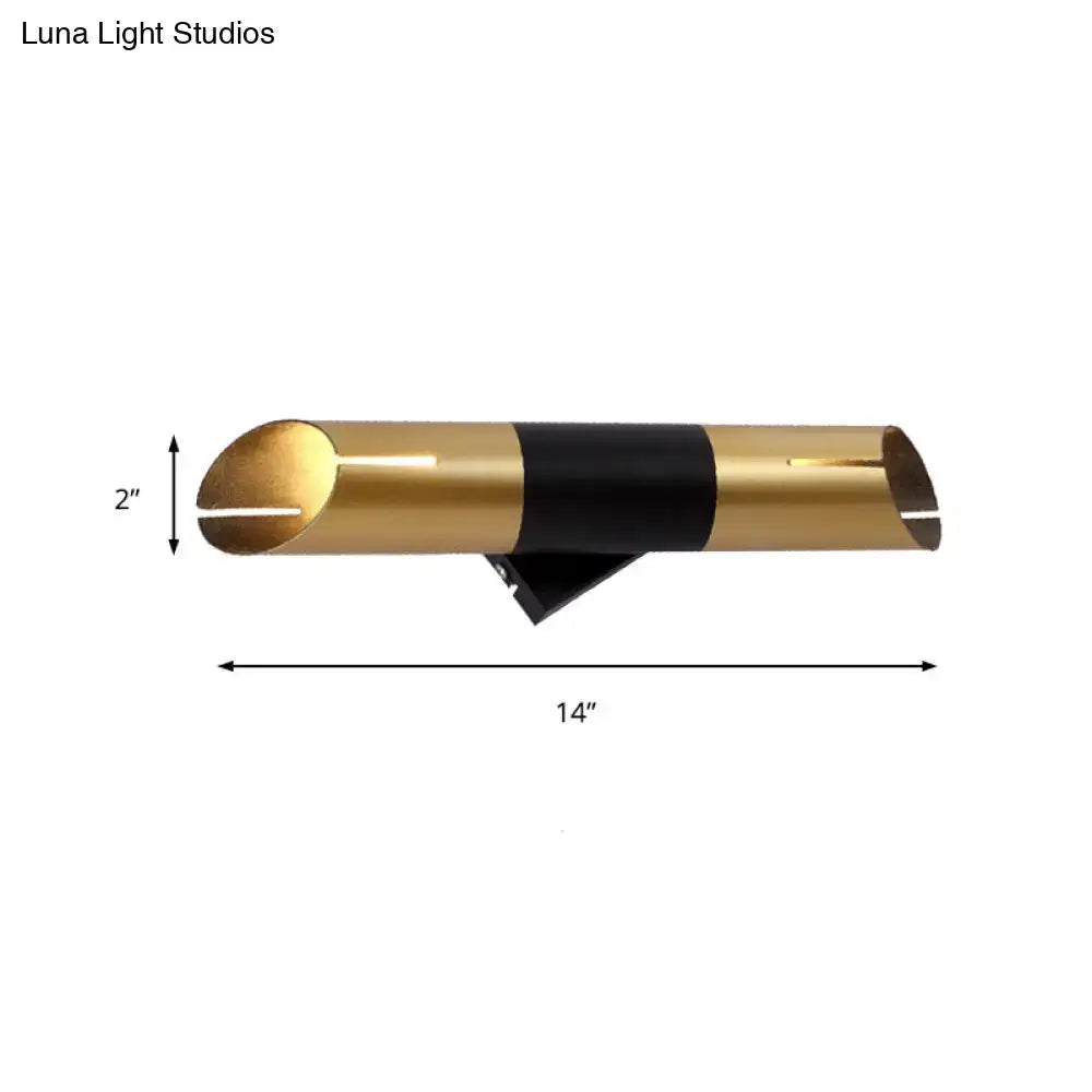 Modern gold and black rotatable cylinder wall sconce with a sleek dual-tone design for bedroom lighting