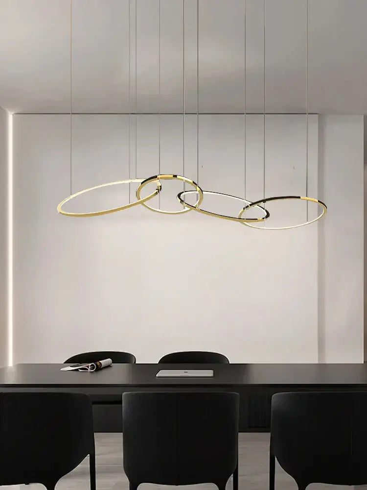Modern gold and black stainless steel pendant lights with sleek interlocking ring design for dining room decorbites gold stainless