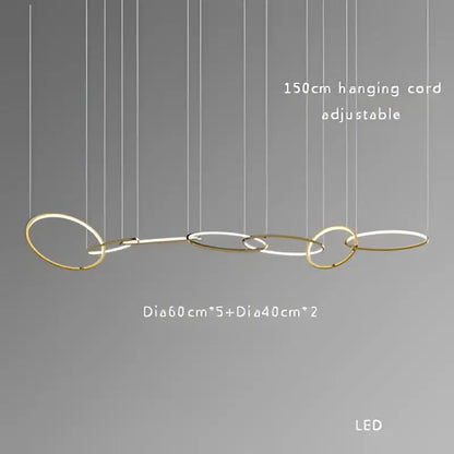 Modern gold and black stainless steel pendant lights with interconnected gold-toned rings and led illumination for dining room decorbites gold stainless