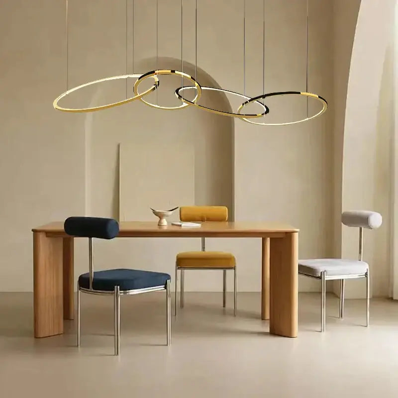 Modern gold and black stainless steel pendant lights with interlocking circular rings for dining room decorbites gold stainless