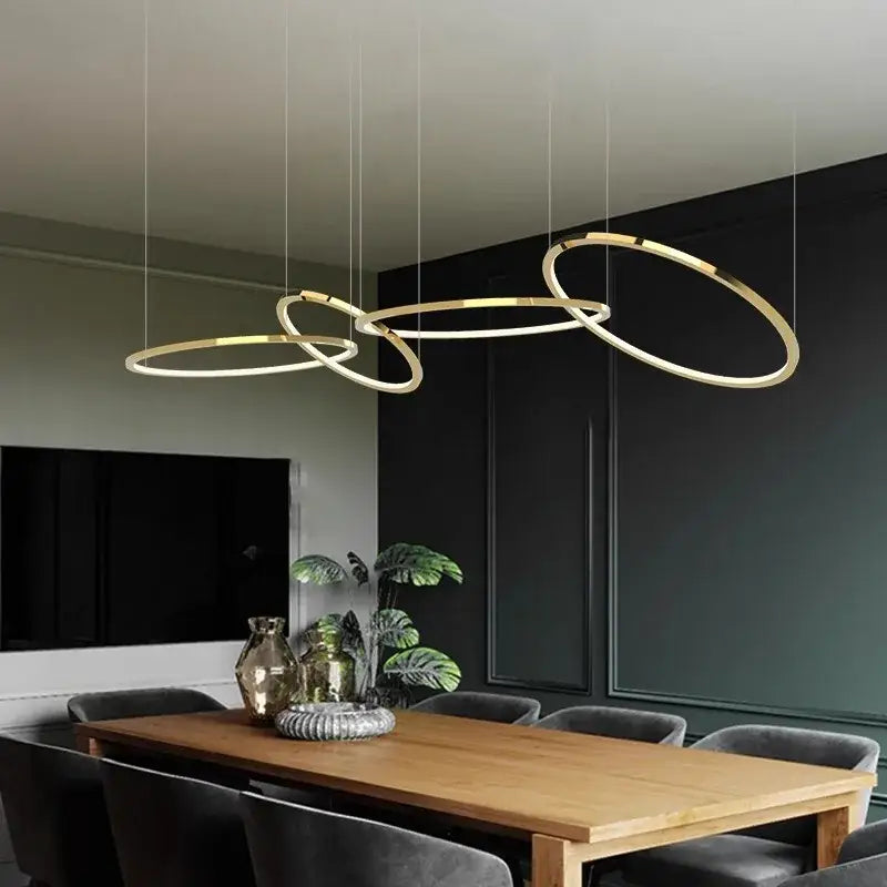Modern gold stainless steel pendant lights with sleek interlocking ring design for dining room decorbites gold stainless