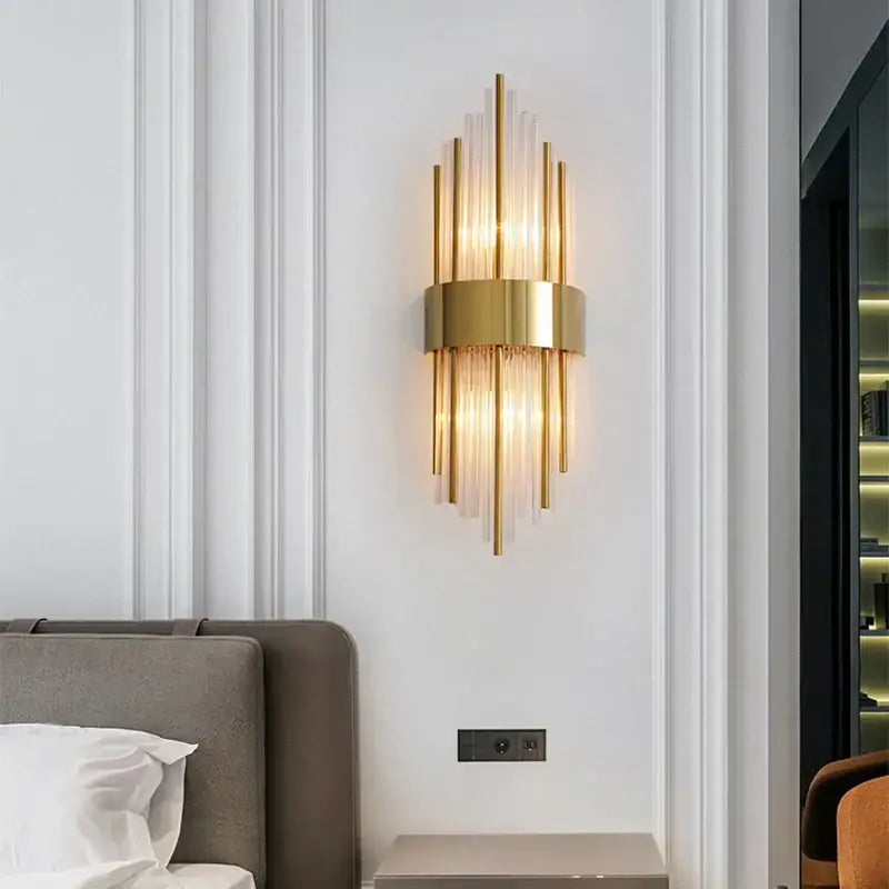 Modern gold stainless steel wall sconce with vertical glass rods and circular base for living room decorbites gold stainless