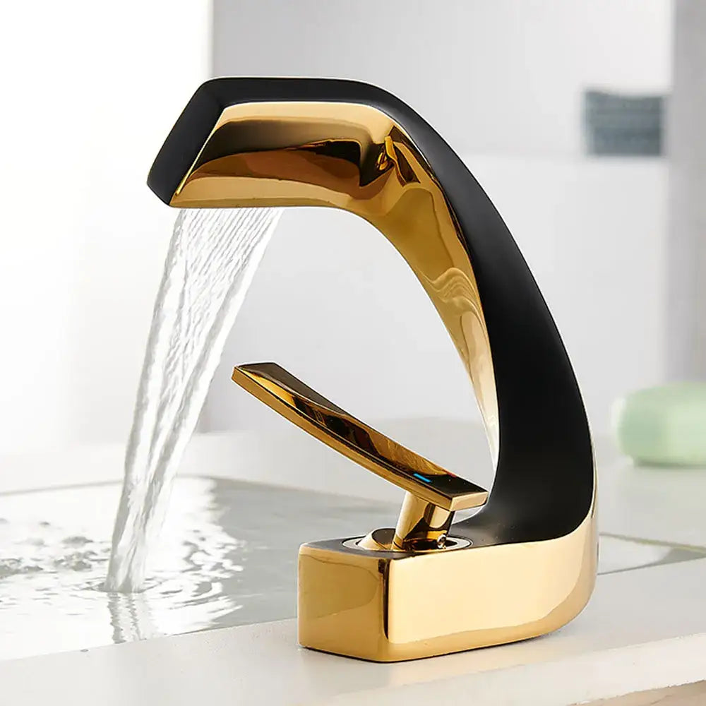 Modern gold and black waterfall basin faucet with sleek curved design for bathroom fixture use