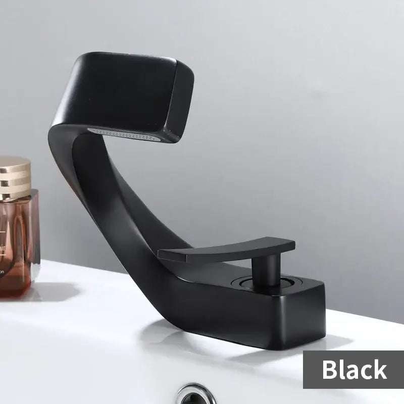 Modern gold and black waterfall basin faucet with black matte finish, sleek curved design, and rectangular handle